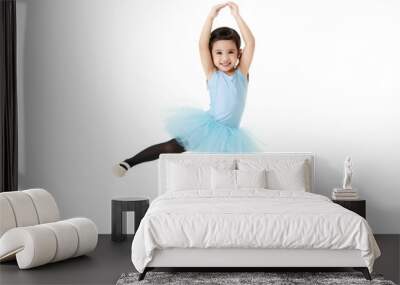 Portrait isolated studio shot of small pretty Asian preschool pigtails ballerina dancer girl in blue tutu ballet dress black legging standing smiling posing hold hands and leg up on white background Wall mural