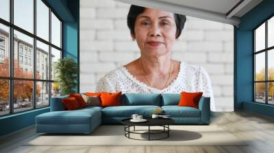 Portrait of an older senior Asian woman with a smiling face. Wall mural