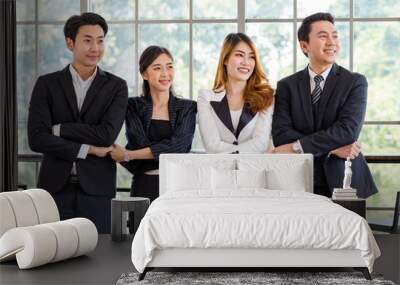 Portrait shot group of Asian happy cheerful millennial professional successful male businessman and female businesswoman in formal suit standing smiling cross hands holding together showing teamwork Wall mural