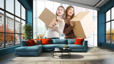 Portrait two roommates happy young Asian female moving packing things in box into new apartment, carry cardboard boxes, Concept teenage or friends, Real estate property buying, relocation, new home Wall mural