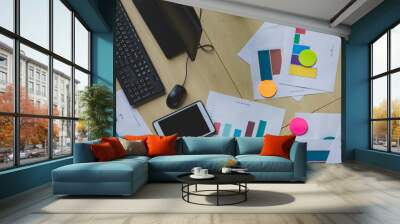 Top view flat lay shot of a group of document financial income graph paperwork, keyboard, mouse, and computer on a modern wooden table. Concept of business and working desk stuff in the office Wall mural