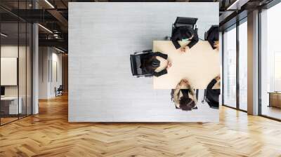 Top view of meeting conference wooden table with six executives businesswomen sitting on each chairs discussing and talking business in team work in meeting room Wall mural