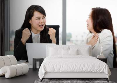 Two Asian professional successful friendly female businesswoman colleague in formal suit take coffee break have funny talking conversation and laughing together in company office with laptop computer Wall mural