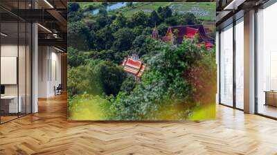 Background of high angle view from the top of the mountain where you can see the grassland, rice fields, large reservoir and clear sky during the adventure travel. Wall mural