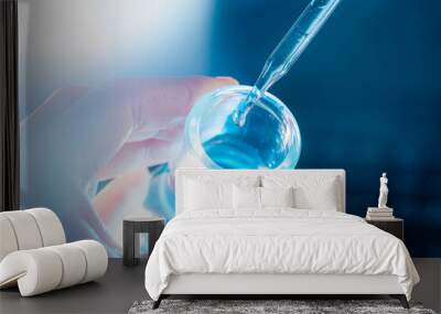 Flask in scientist hand with test tubes Wall mural