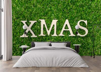 Wood letter in word xmas on green grass background (Concept for Christmas) Wall mural