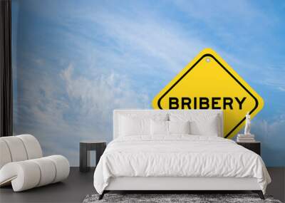 Yellow transportation sign with word bribery on blue color sky background Wall mural