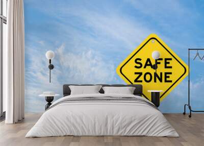 Yellow transportation sign with word safe zone on blue color sky background Wall mural