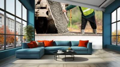 A construction worker pouring a wet concret at road construction site Wall mural