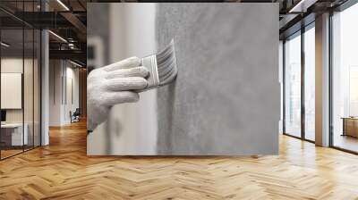 hand of worker use brush for color paint concrete Loft style on wall Wall mural