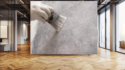 hand of worker use brush for color paint concrete Loft style on wall Wall mural