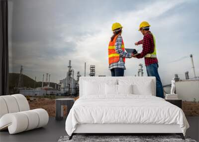 Refinery industry engineer  wearing PPE Working at refinery construction site Wall mural