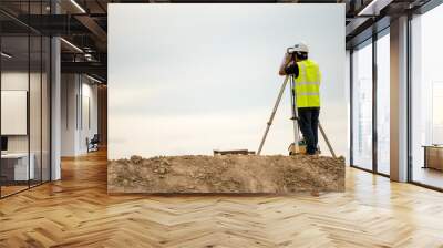 survey engineer in construction site use theodolite mark a concrete pile co ordinate Wall mural