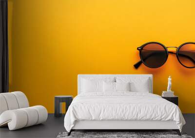 Round sunglasses banner image. Stylish round sunglasses isolated on orange background with copy space. Wall mural