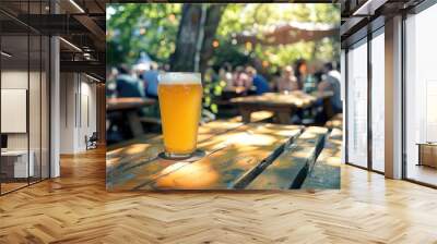 Cheers to Beer Day: Refreshing Golden Beer in Frosty Glass at Lively Beer Garden Celebration on Sunny Afternoon Wall mural