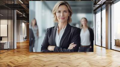 portrait of a businesswoman. smile and relaxing . miidle age of woman and team .  office and tower view background. Wall mural