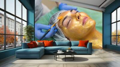 the client makes a procedure for the care of a mask of gold close-up Wall mural