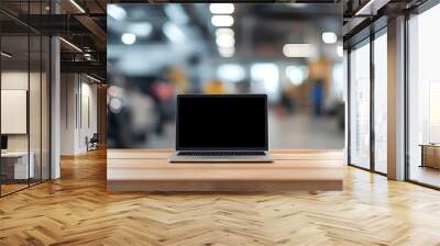 Laptop with blank screen on wooden table in car dealership. Wall mural