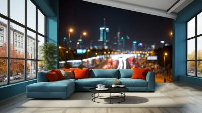 Bright glowing lights of district in megapolis under dusk sky in evening on blurred background Wall mural