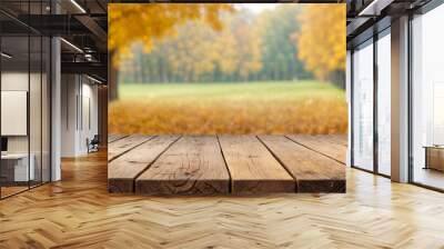 The empty wooden table top with blur background of autumn Maple leaves. Exuberant image Wall mural