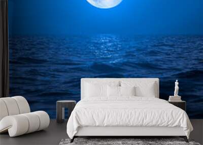 Full moon rising over empty ocean at night Wall mural