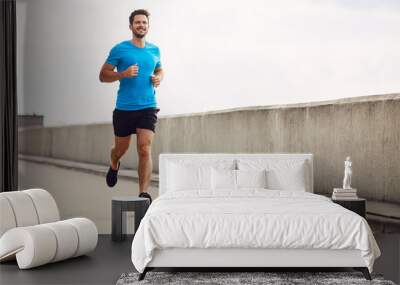 Athletic young man running Wall mural