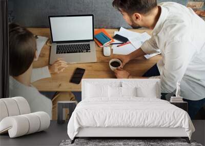 Closeup of two business people looking at empty blank laptop screen Wall mural