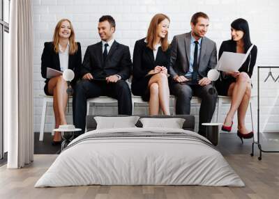 Group of happy business people sitting in waiting room Wall mural