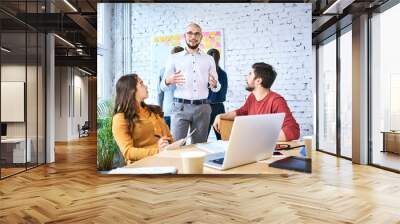 Group of students discussing and studying together in classroom. Startup businesspeople during meeting Wall mural