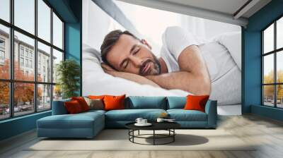 handsome man sleeping in bed Wall mural