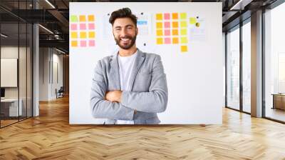 Handsome young startup entrepreneur smiling at camera Wall mural