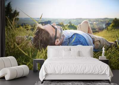 Man relaxing during hiking trip in the mountains Wall mural