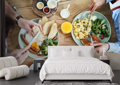 Overhead picture of couple eating tasty breakfast at restaurant. Wall mural