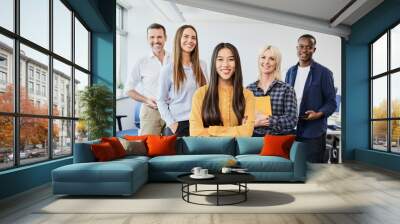 Portrait of diverse group of colleagues standing together in startup office Wall mural