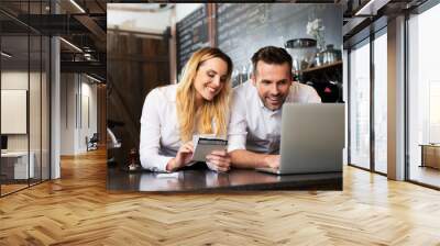 Two cafe managers working on laptop Wall mural