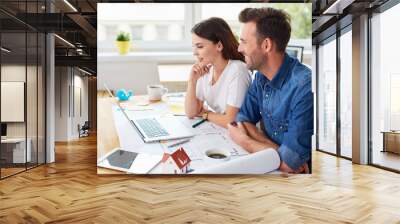 Two designers architects working together with laptop sitting at table Wall mural