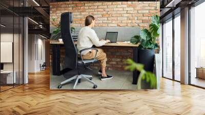 Unrecognisable businesswoman working on laptop in office Wall mural