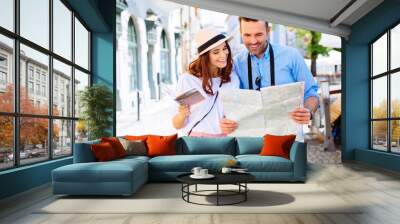 Young couple on a sightseeing tour in Europe Wall mural