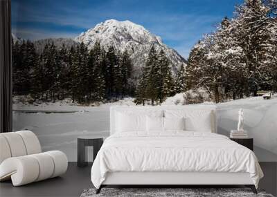 alpine mountain pass winter scenery landscape by lake lago del predil in sunny blue sky in snowfall, italy Wall mural