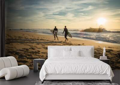 enthusiastic surfers going for surf session in scenic beautiful sunset seascape in capbreton, france Wall mural