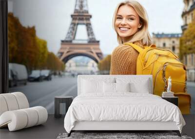 A beautiful blonde woman with a backpack standing on the streets of Europe,the Eiffel Tower in the background, copy space   Wall mural