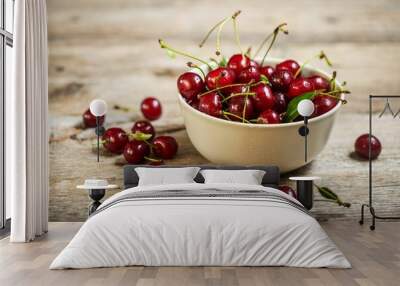 Closeup of fresh red cherries in a bowl on wooden background Wall mural