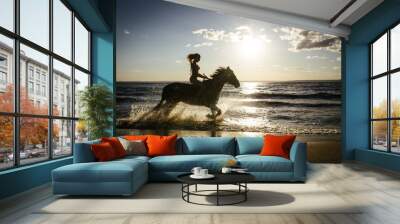 Horseback horse riding on coastline at the beach on sunset background Wall mural