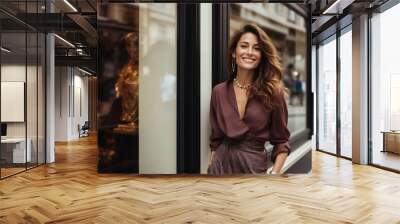 Smiling woman posing outside a luxury store. Wall mural