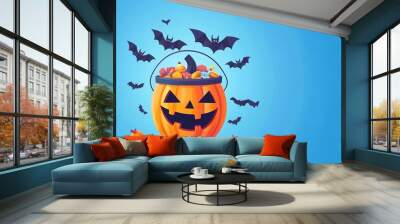 halloween poster : bucket of halloween sweets on blue background with space for text Wall mural