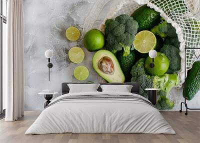 Cotton mesh bag with fresh broccoli, avocados and limes. Eco friendly shopping and healthy lifestyle concept. Generative AI Wall mural