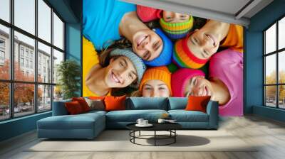 Group of friends wearing in clothes lying in a circle and smiling Wall mural