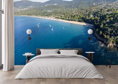 Aerial view on boats, crystal clear blue water of Plage du Debarquement white sandy beach near Cavalaire-sur-Mer and La Croix-Valmer, summer vacation on French Riviera, Var, France Wall mural