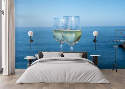 Drinking of white wine with view on blue Atlantic ocean on Tenerife, Canary islands, Spain Wall mural