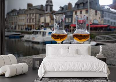 Tasting of apple calvados drink in old Honfleur harbour with boats and old houses on background, Normandy, France Wall mural